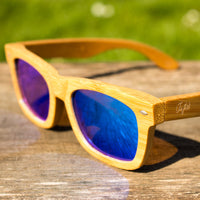 Blue Rayban Jnglst Bamboo Sunglasses on Table