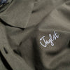 Close up Junglist logo on our Olive Polo Shirt